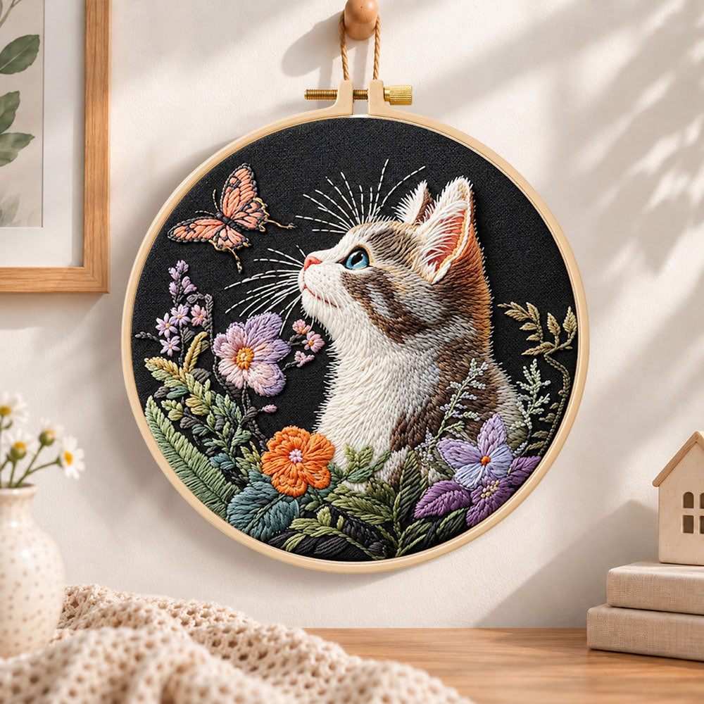 Curious cat and pink butterfly embroidery hoop wall art displayed as warm and cosy handmade home decor