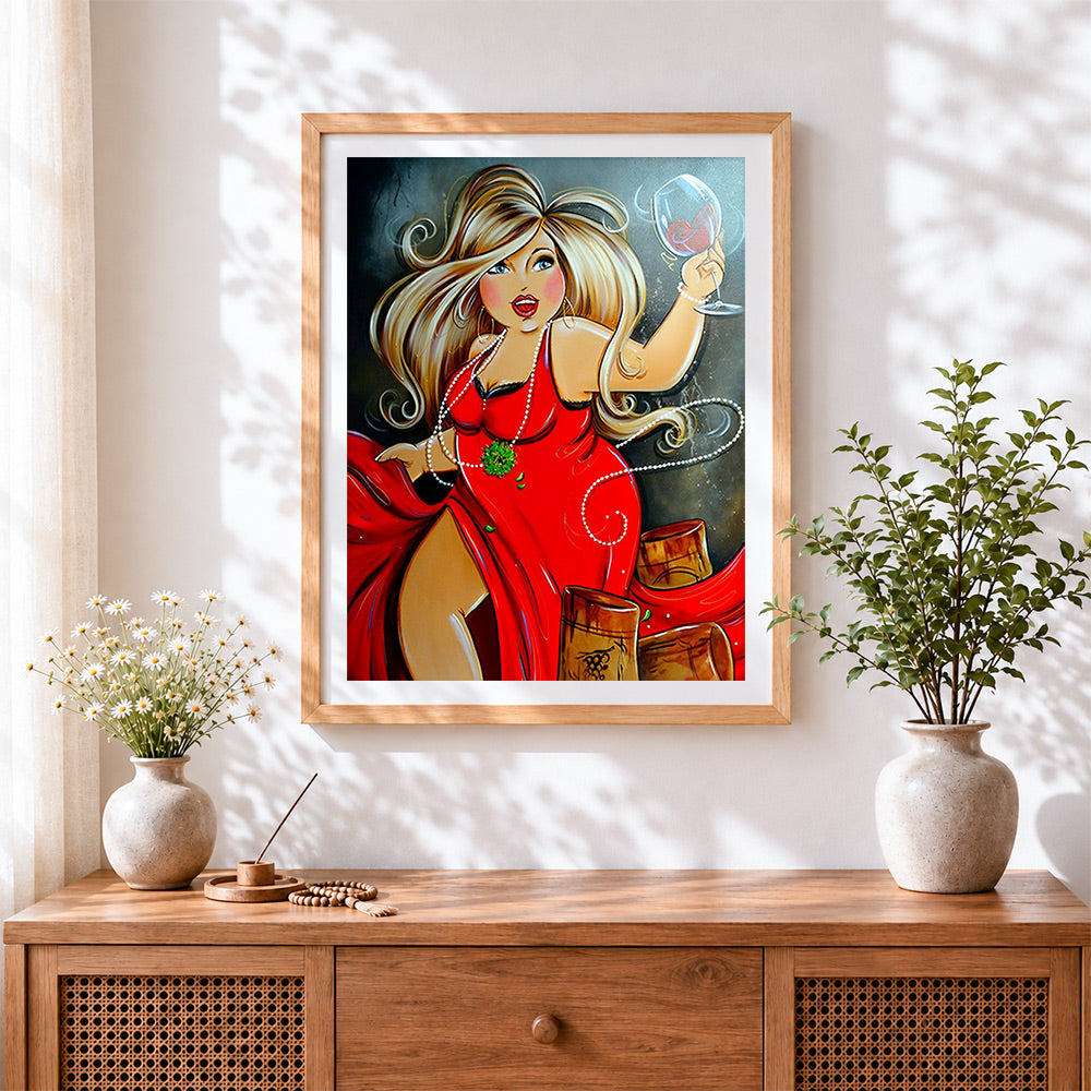 Finished curvy blonde woman with red wine cross stitch artwork displayed