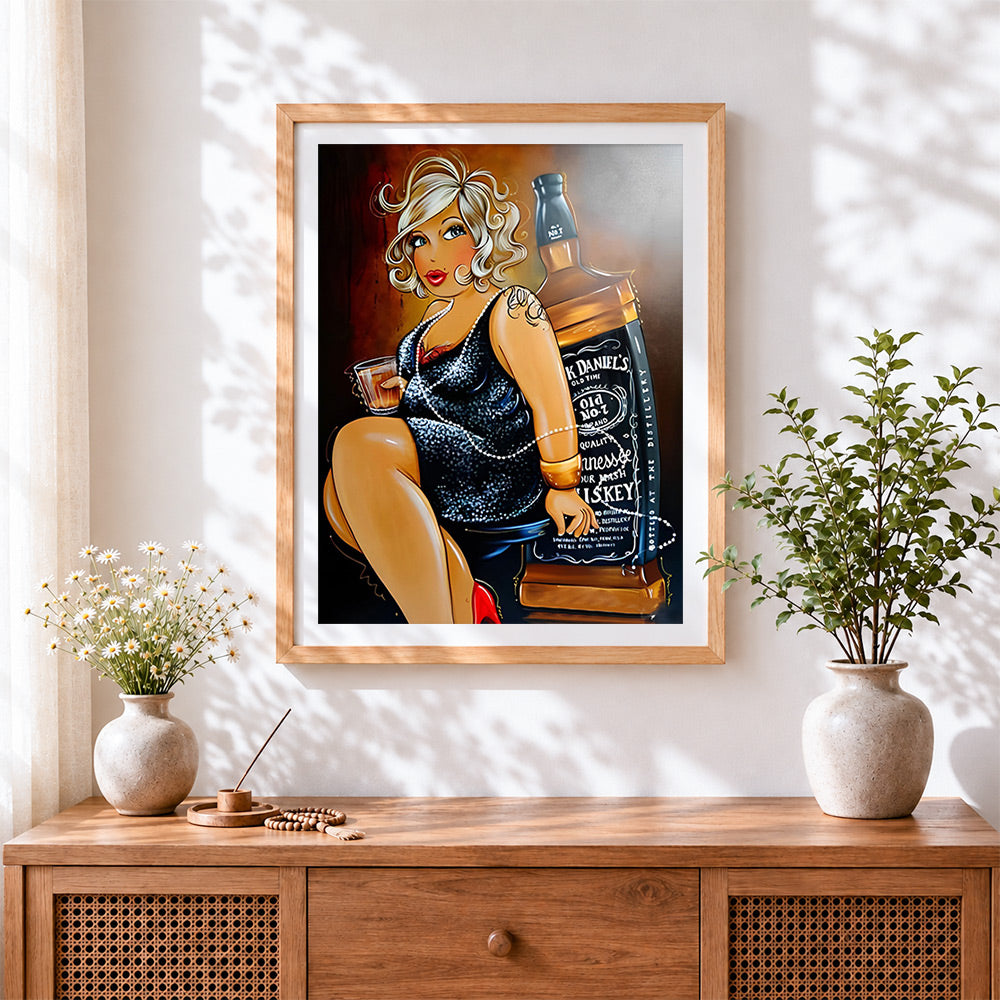 Finished curvy blonde woman with whiskey cross stitch artwork displayed