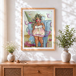 Finished curvy woman and champagne cross stitch artwork displayed