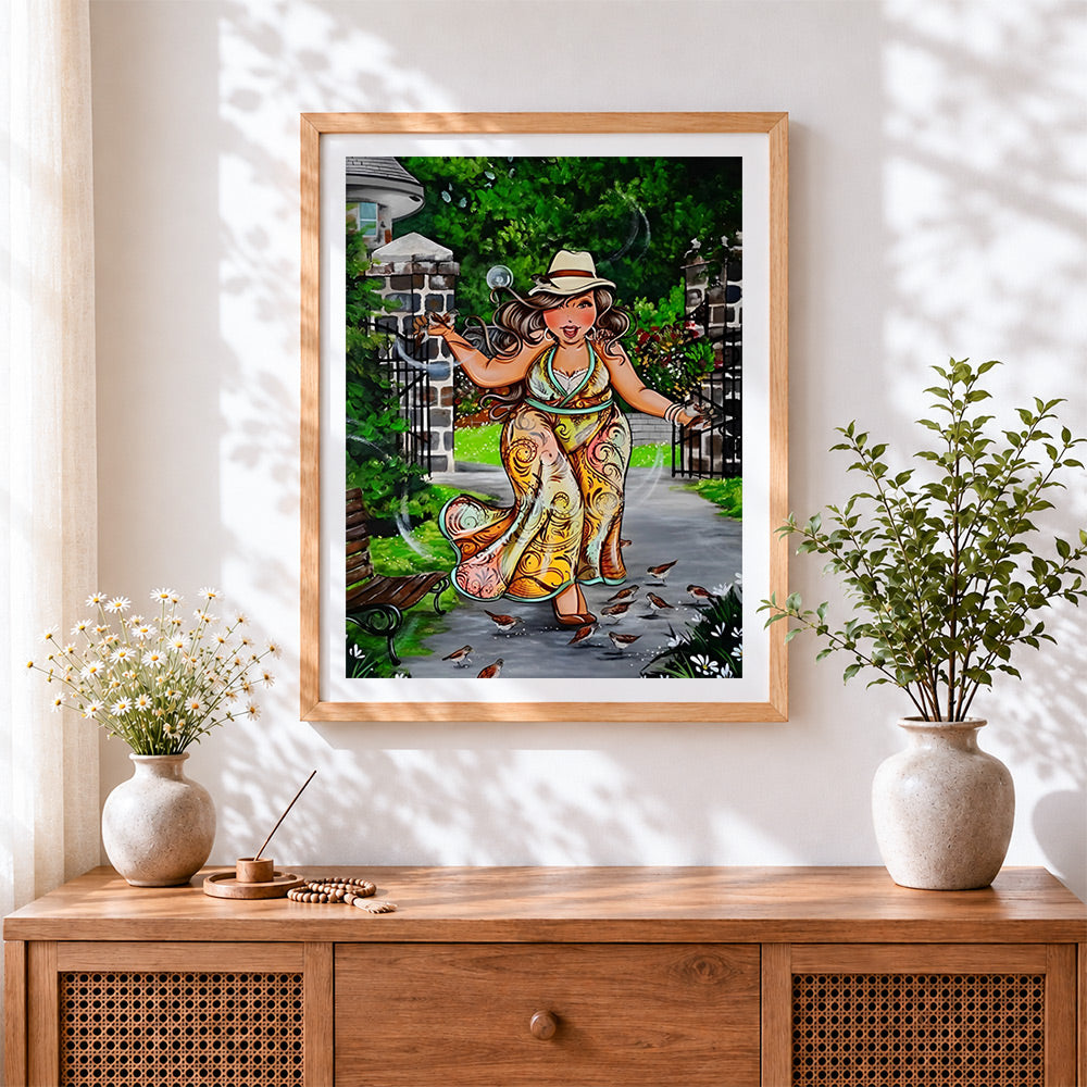 Finished curvy woman feeding birds in garden cross stitch artwork displayed