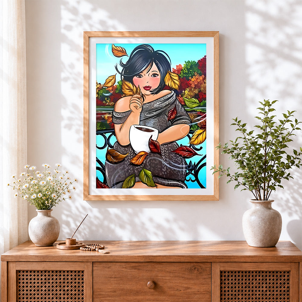 Finished curvy woman with coffee in autumn cross stitch artwork displayed