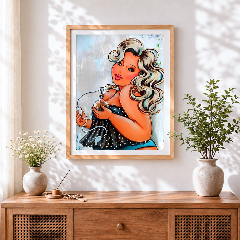 Finished curvy woman with perfume bottle cross stitch artwork displayed