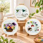 Cute animal themed stitch work embroidery kit finished hoop displayed on a wooden stand as cozy tabletop decor