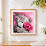 Finished cute bear with pink gerbera paint by numbers artwork displayed as home decor