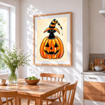 Cute black cat in a pumpkin cross stitch artwork displayed on wall as home decor