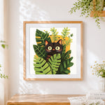 Finished cute black cat peeking through monstera leaves cross stitch artwork displayed