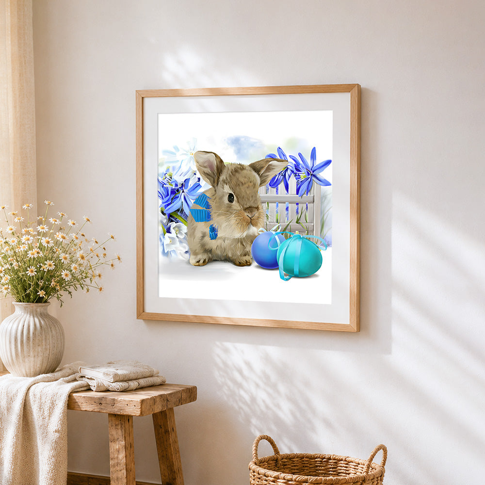 Cute bunny blue flowers and easter eggs cross stitch artwork displayed on wall as home decor
