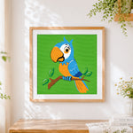 Finished cute cartoon blue parrot cross stitch artwork displayed
