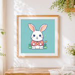 Finished cute cartoon bunny in a red coat cross stitch artwork displayed