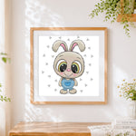 Finished cute cartoon bunny in dungarees cross stitch artwork displayed