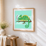 Cute chameleon catching a fly cross stitch artwork displayed on wall as home decor