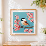Finished cute chickadee on cherry blossom branch cross stitch artwork displayed