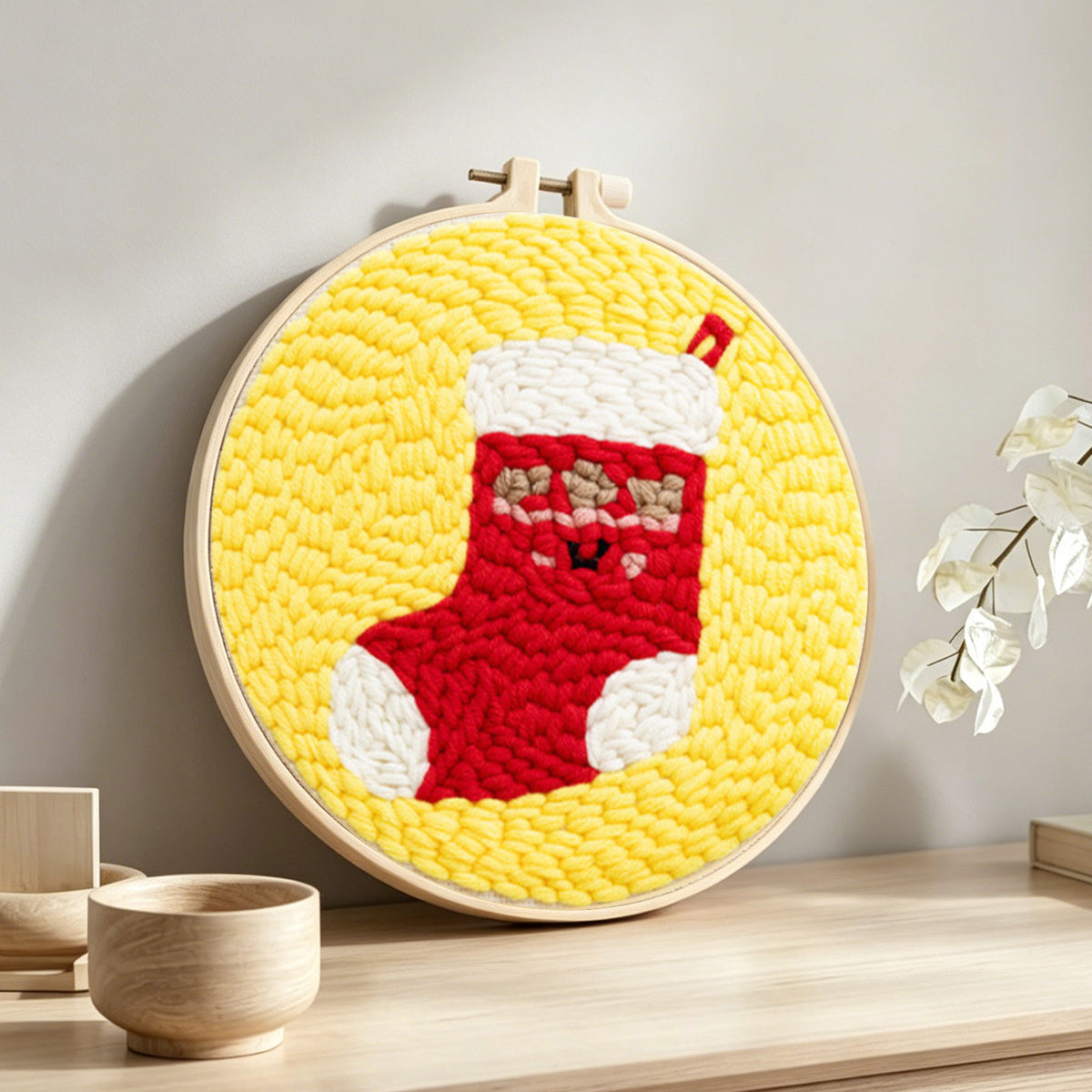 Cute christmas stocking punch needle artwork displayed on a table
