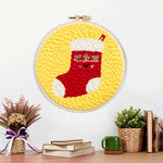 Finished cute christmas stocking artwork displayed on a wall