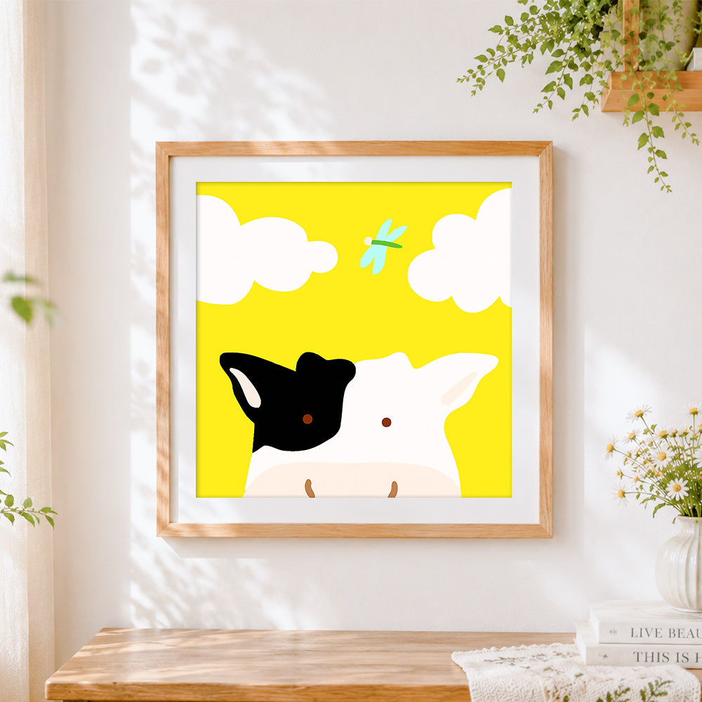 Finished cute cow and dragonfly cross stitch artwork displayed