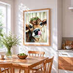 Cute cow with tongue out cross stitch artwork displayed on wall as home decor