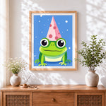 Finished cute frog in a party hat cross stitch artwork displayed