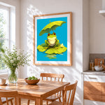 Cute frog with umbrella on a lily pad cross stitch artwork displayed on wall as home decor