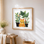 Cute ginger cat with potted houseplants cross stitch artwork displayed on wall as home decor