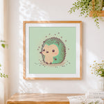 Finished cute green hedgehog cross stitch artwork displayed