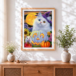 Finished cute halloween cat with jack-o'-lantern cross stitch artwork displayed