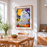 Cute halloween cat with jack-o'-lantern cross stitch artwork displayed on wall as home decor