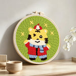 Cute happy tiger punch needle artwork displayed on a table