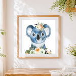 Finished cute koala with floral crown cross stitch artwork displayed