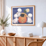 Cute little ghosts and pumpkin cross stitch artwork displayed on wall as home decor