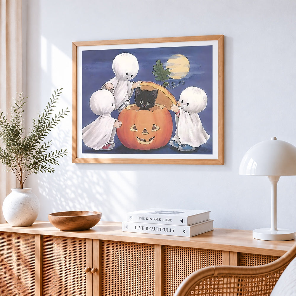 Cute little ghosts and pumpkin cross stitch artwork displayed on wall as home decor