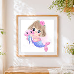Finished cute mermaid and jellyfish cross stitch artwork displayed