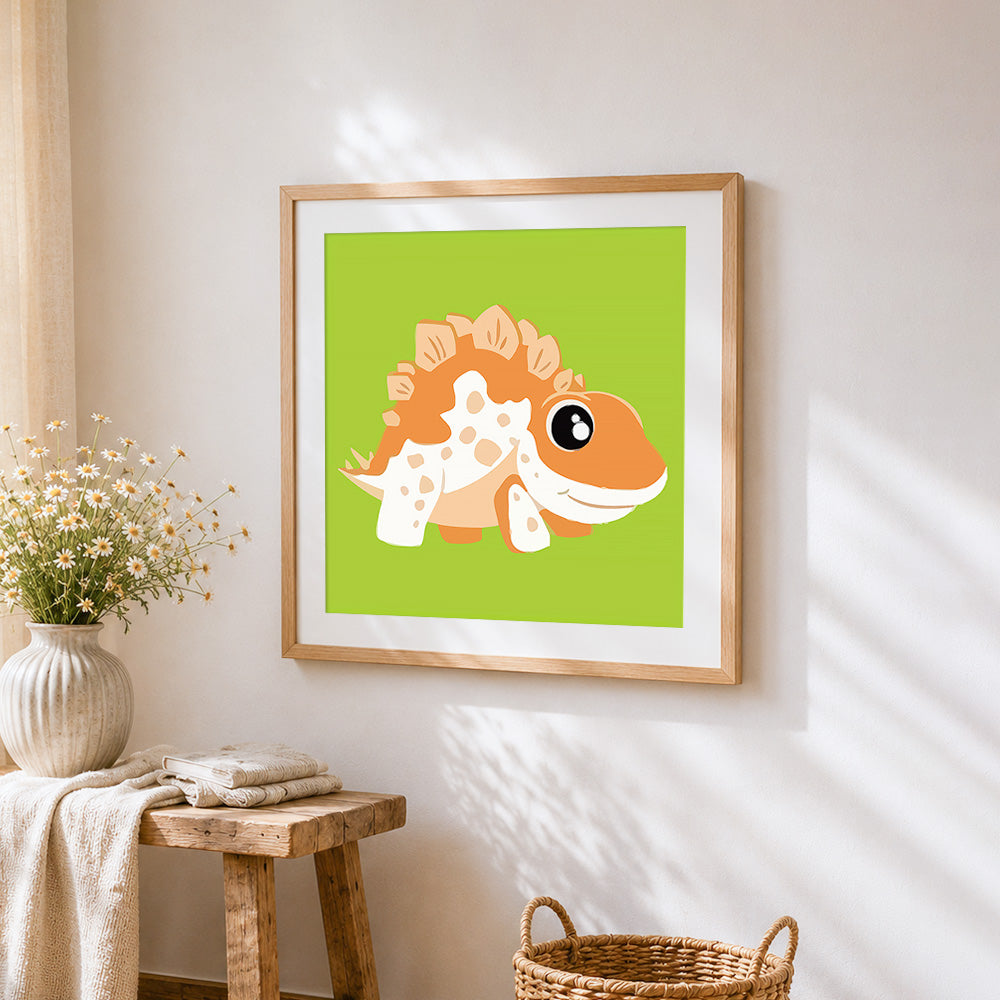 Cute orange spiky dinosaur cross stitch artwork displayed on wall as home decor