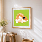 Cute orange spiky dinosaur cross stitch artwork displayed on wall as home decor