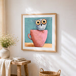 Cute owl in pink teacup cross stitch artwork displayed on wall as home decor