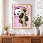 Finished cute panda in a cherry blossom tree cross stitch artwork displayed