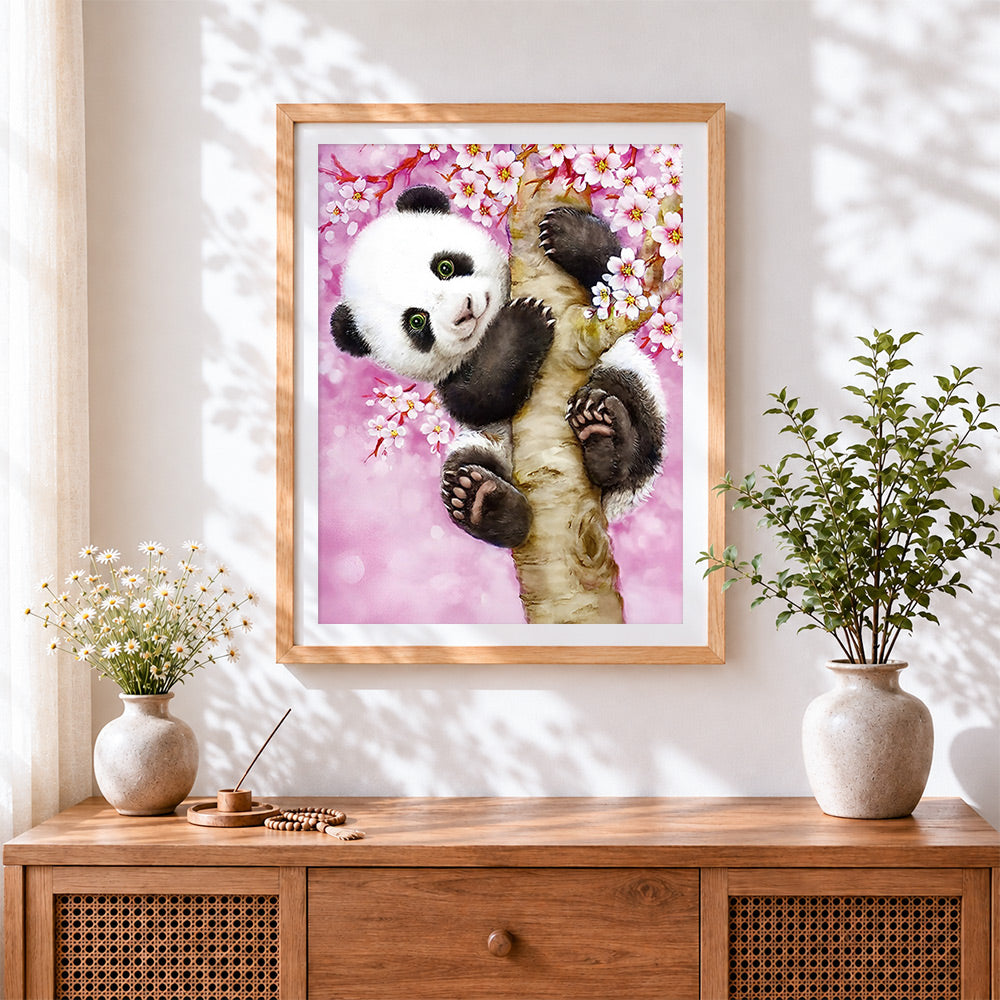 Finished cute panda in a cherry blossom tree cross stitch artwork displayed