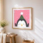 Cute penguin with party hat cross stitch artwork displayed on wall as home decor