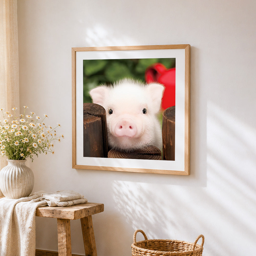 Cute piglet peeking over fence cross stitch artwork displayed on wall as home decor