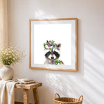 Cute raccoon with floral crown cross stitch artwork displayed on wall as home decor