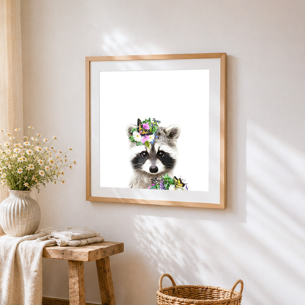 Cute raccoon with floral crown cross stitch artwork displayed on wall as home decor