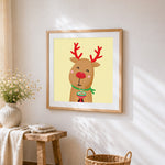 Cute reindeer with hot chocolate cross stitch artwork displayed on wall as home decor