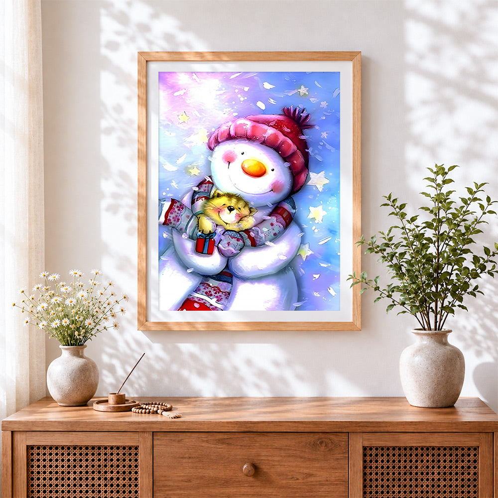 Finished cute snowman and kitten cross stitch artwork displayed
