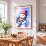 Cute snowman and kitten cross stitch artwork displayed on wall as home decor
