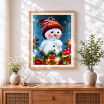 Finished cute snowman in a knitted hat cross stitch artwork displayed