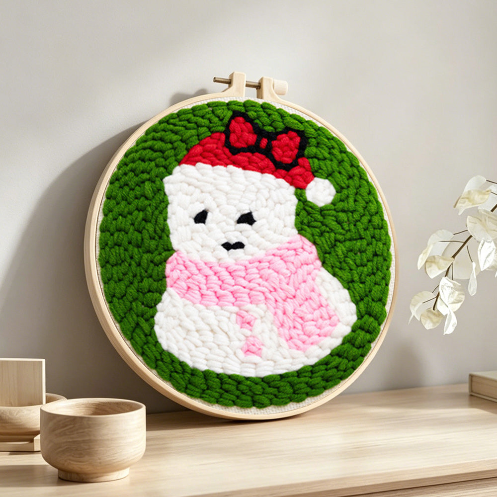 Cute snowman in santa hat punch needle artwork displayed on a table
