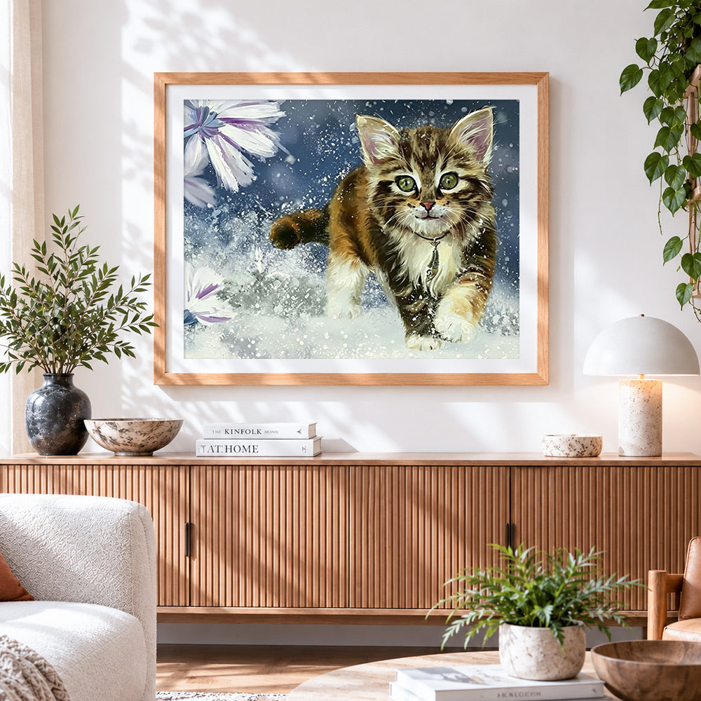 Finished cute tabby kitten running in snow cross stitch artwork displayed