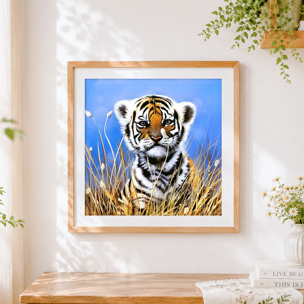 Finished cute tiger cub in tall grass cross stitch artwork displayed