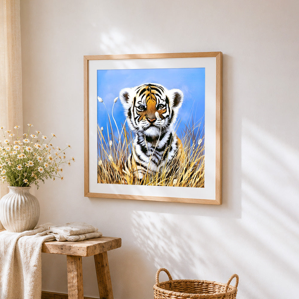 Cute tiger cub in tall grass cross stitch artwork displayed on wall as home decor