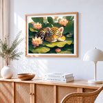 Cute tiger cub sleeping on a lotus leaf cross stitch artwork displayed on wall as home decor